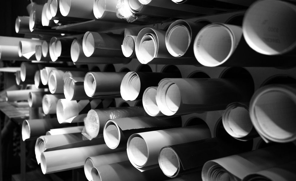 Vinyl film of different colors in round tubes. Advertising production. A store selling self-adhesive films.